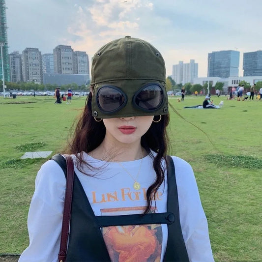 “DeathVision: Aviator Shade Cap for Rebels, Ragers & Runaways” – Built-In Sunglasses Hat for Those Who Don’t Just Dodge the Sun… They Dodge the Law